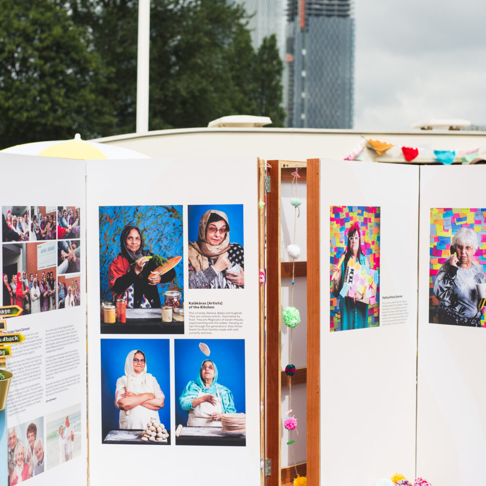 An outdoor display of colourful portrait photography.