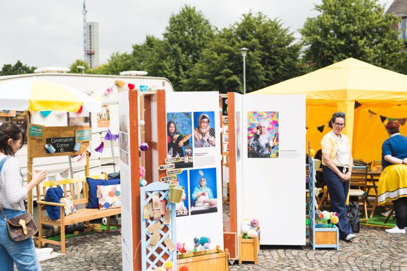 The Golden Years caravan exhibition, displaying portraits, conversation corner, the caravan for films and an activity tent