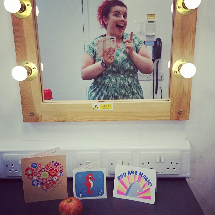 Sarah taking a mirror selfie and grinning