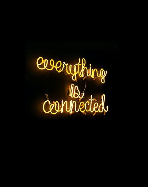 A neon sign reads 'everything is connected'.