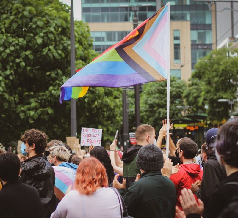 A pride parade, pride flag waving