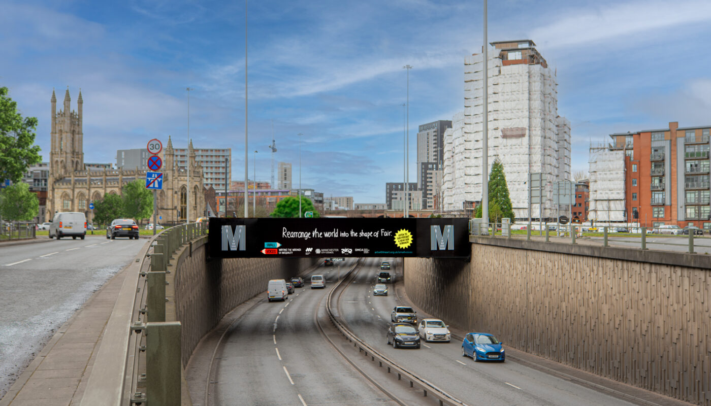 A billboard over the Mancunian Way features children's writing that reads 'Rearrange The World into the Shape of Fair'.