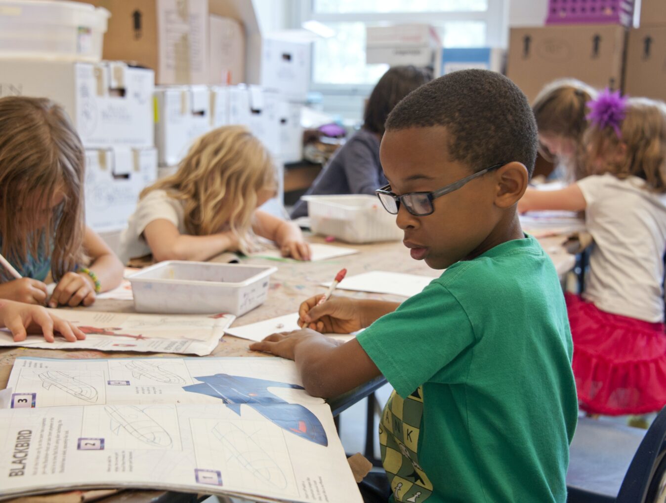 Children work in a classroom.