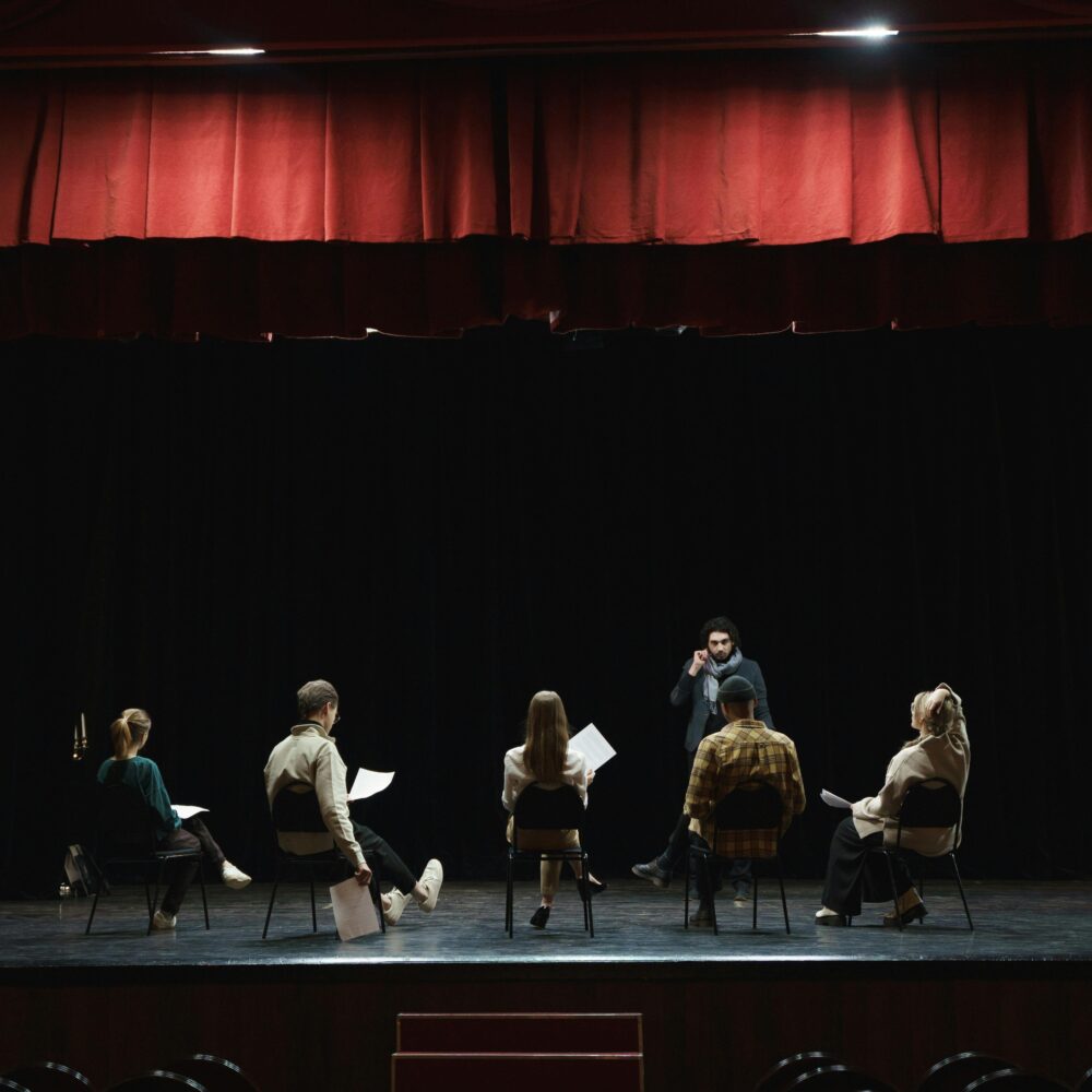 A group of actors rehearsing on stage