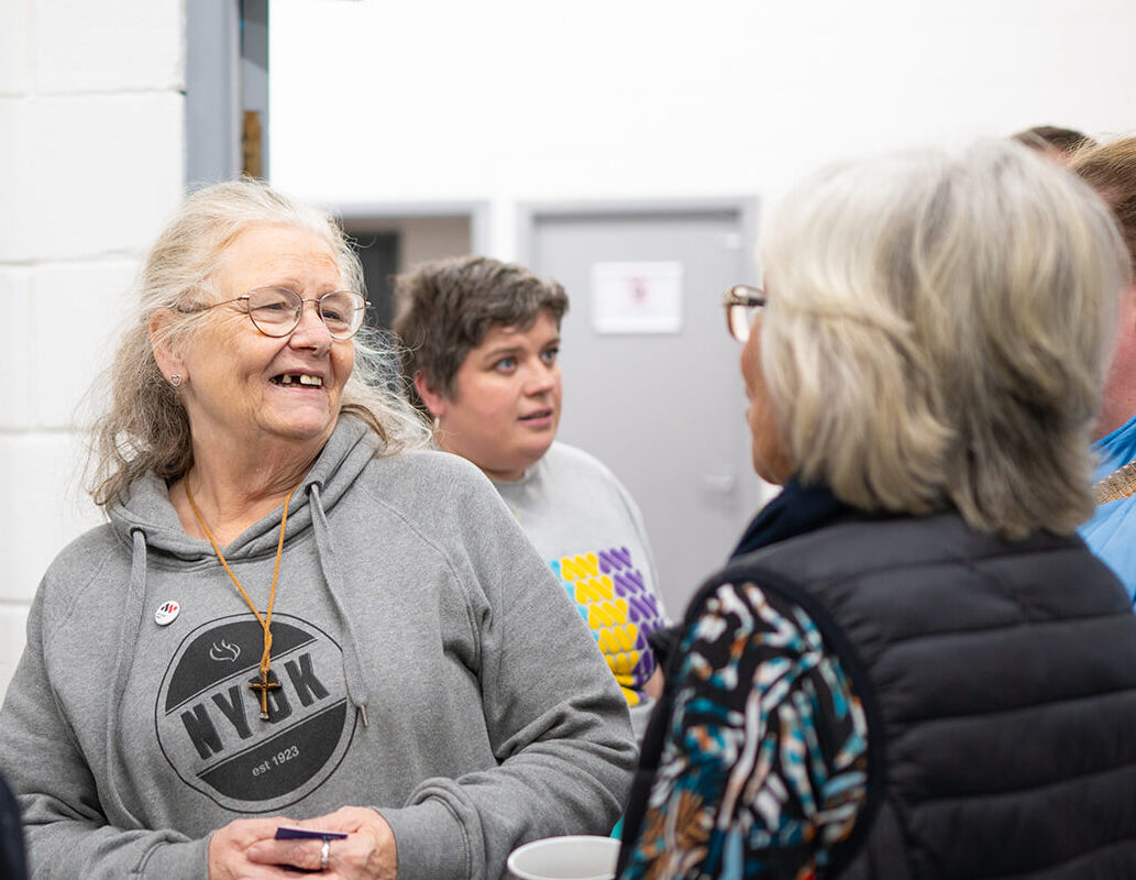 Community collaborators laugh at The Art Show