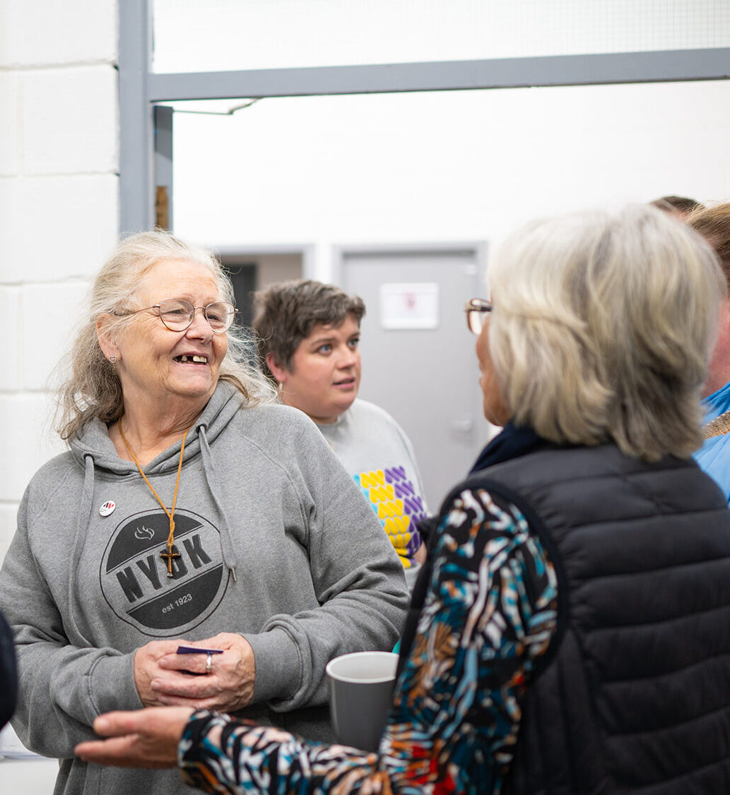 Community collaborators laugh at The Art Show