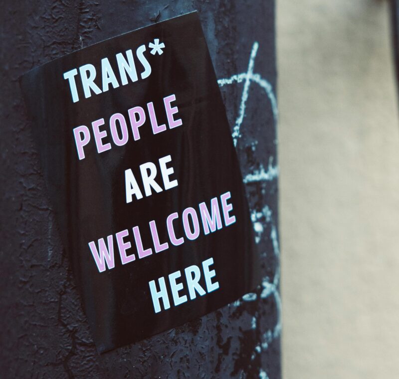 A sticker that reads 'trans people are welcome here' 