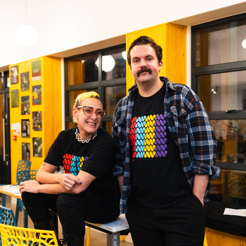 Artists Jae and Louis sit smiling