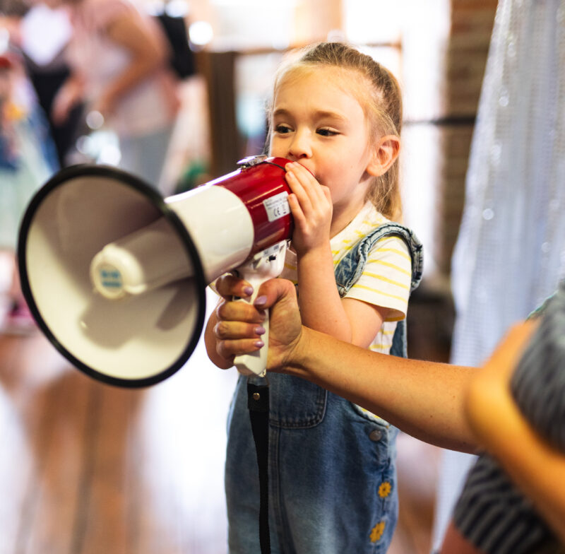 A child shouting into a megaphone