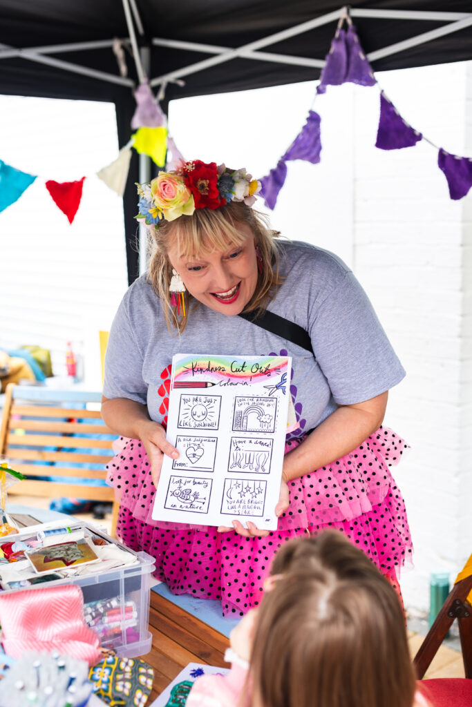 Artist Phoebe showing a drawing to participants