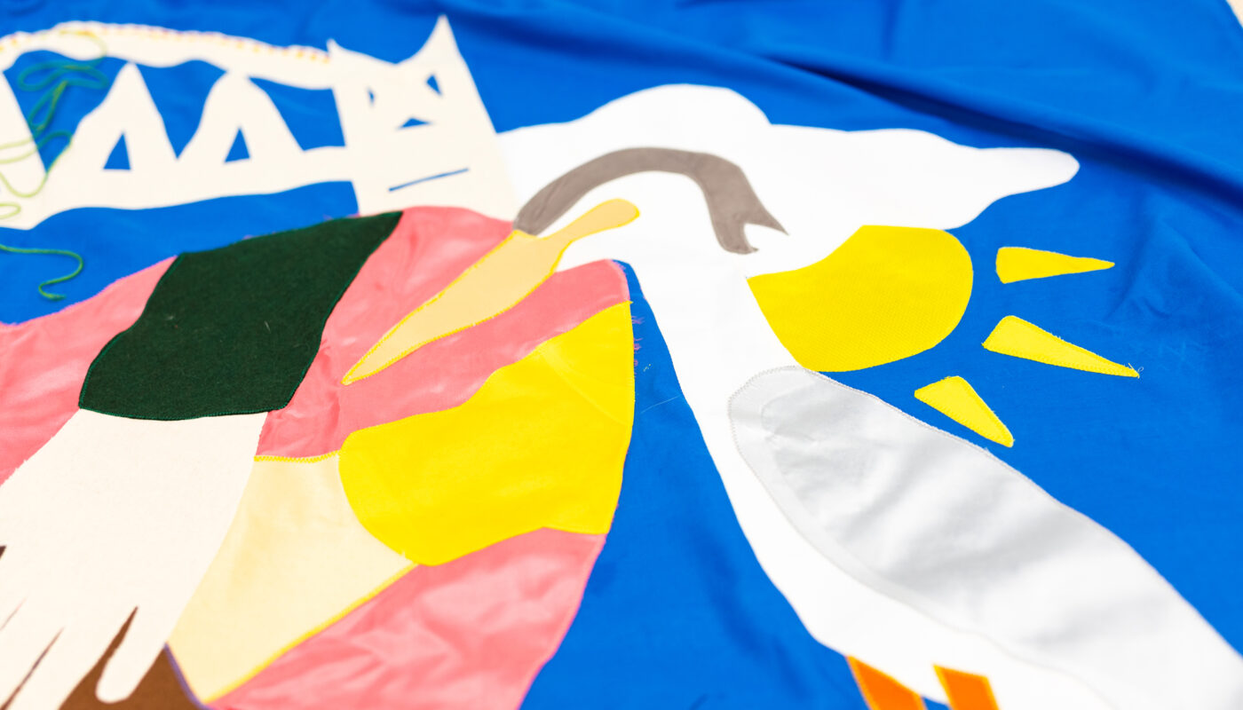 Close up of a heron on a large blue banner