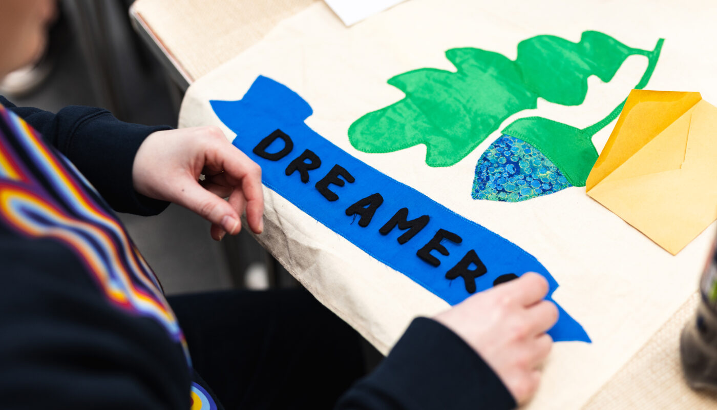 A participant places letters on a small banner