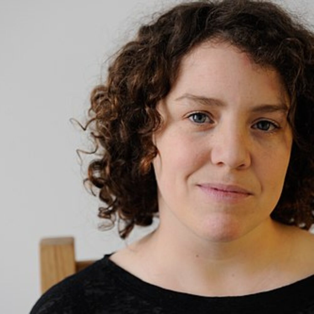 An image of Jess Thom, a woman with brown curly hair.