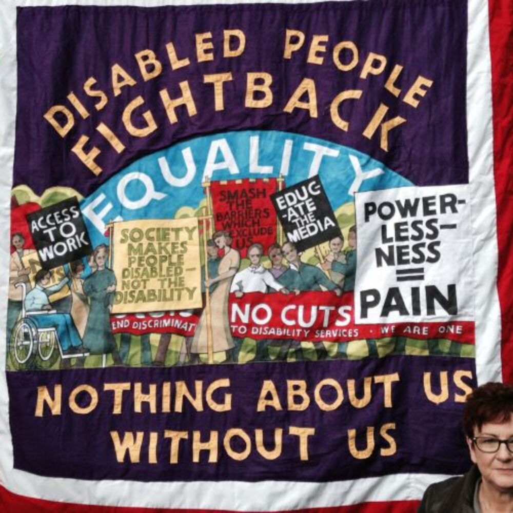 Protest banner Disabled People Fightback, Nothing About Us Without Us