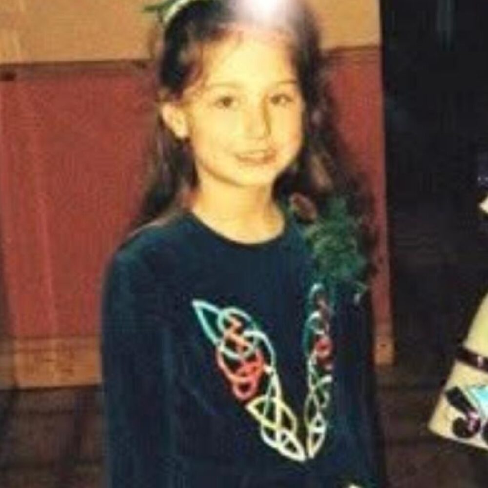 Skai as a young child wearing an irish dancing dress