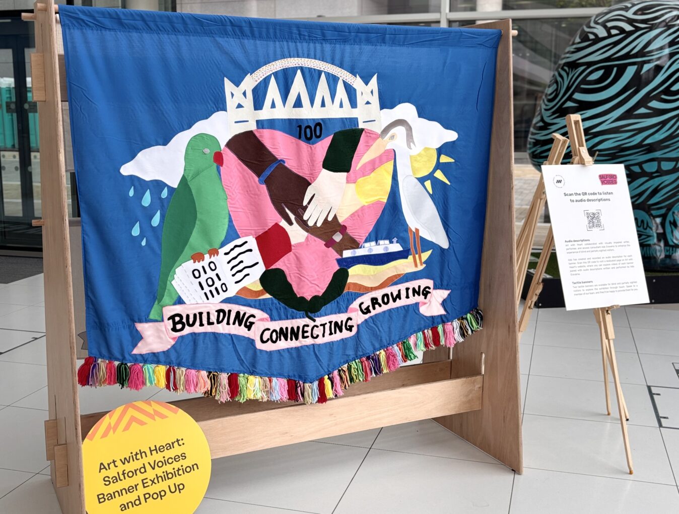 Salford Voices banner on display at We Invented The Weekend Festival