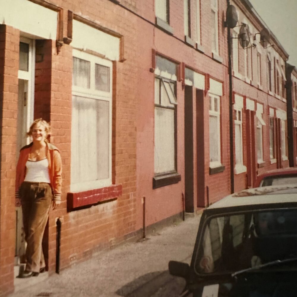 Lorraine standing on the old terraced street she lived in when I first came to Salford.