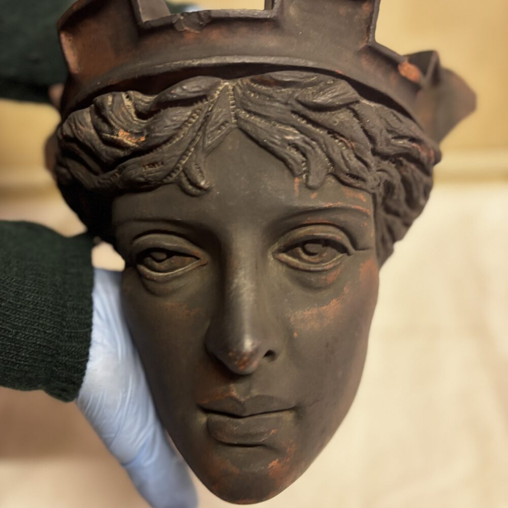 Terracotta head from the Rose & Crown pub. Made from brick and covered in a greying bronze like paint.