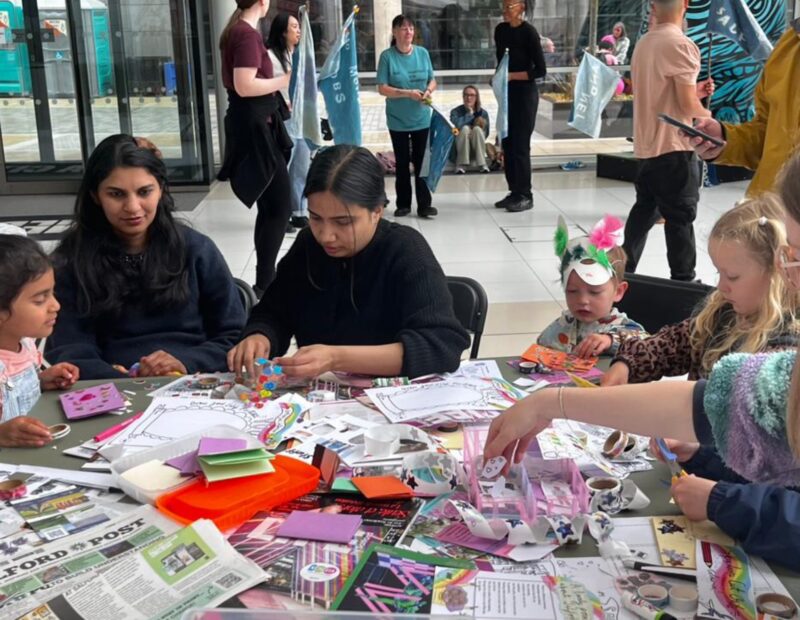 A photo of a group of people doing craft activities.