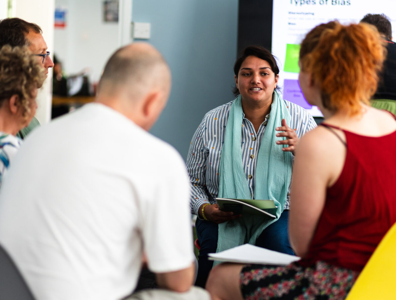A group of work collegue take part in a group discussion during a creative workshop.